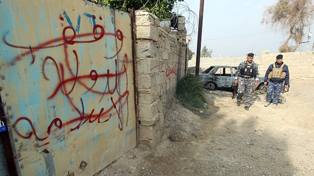 Iraqi policemen ISIL graffiti