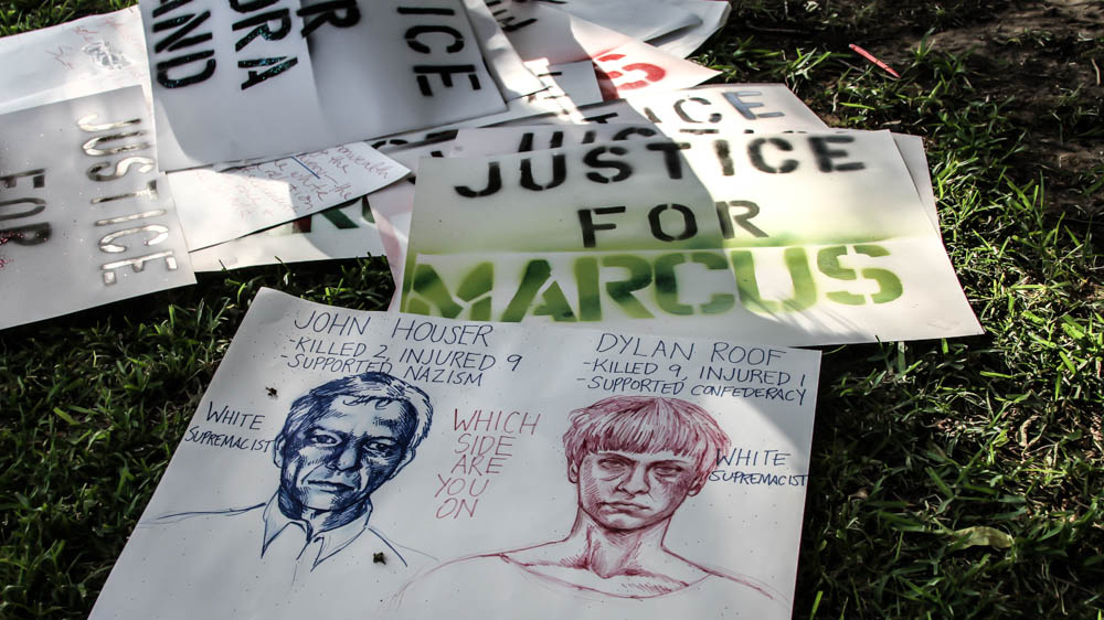 Both protesters and defenders brought their own signs for the demonstrations [Shaghayegh Tajvidi/Al Jazeera]