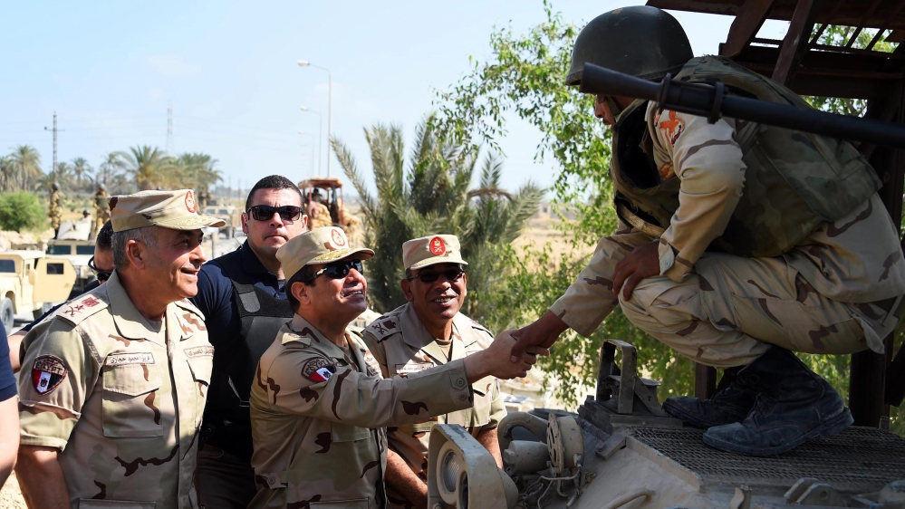 State television broadcast footage of Sisi, dressed in military fatigues, touring an army base [EPA]