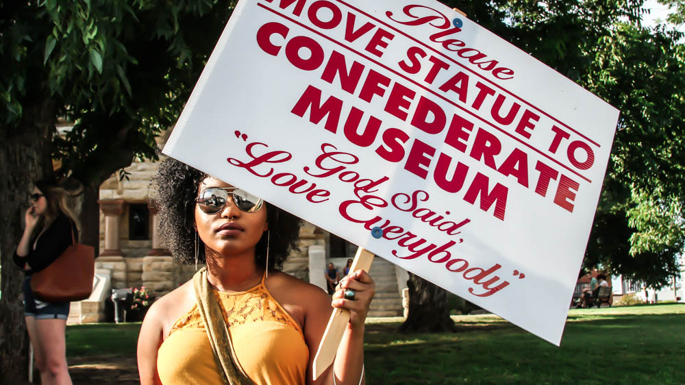 Local activists gathered in front of the Denton Municipal Court House to protest the Confederate Soldier Monument and demand its transfer to a museum  [Shaghayegh Tajvidi/Al Jazeera]