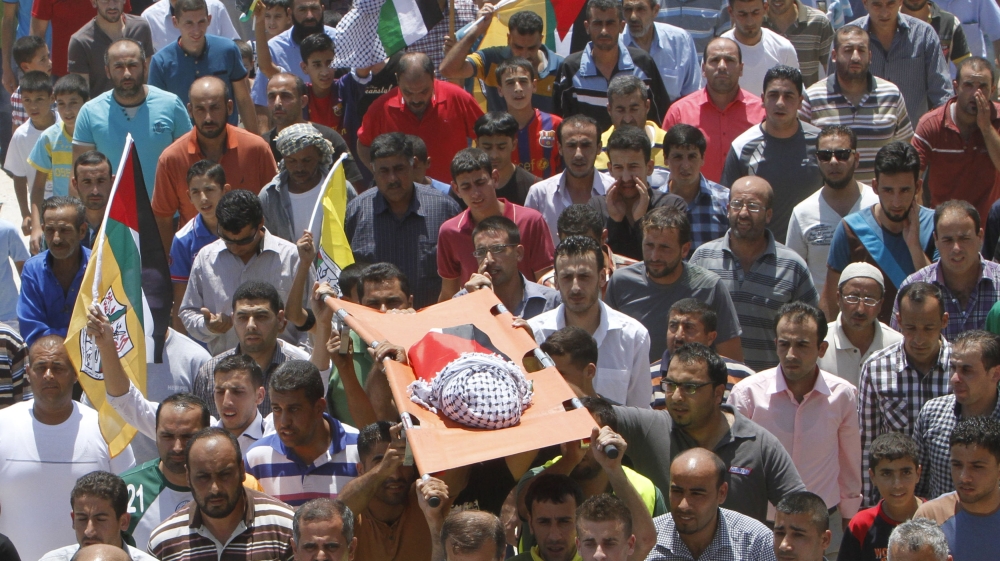 Mourners carry the body of 18-month-old Palestinian baby Ali Dawabsheh, who was killed after his family's house was set on fire in a suspected attack by Jewish extremists in Duma village near Nablus