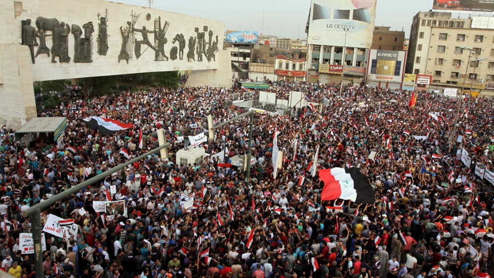People shout slogans during a demonstration at Tahrir Square in central Baghdad
