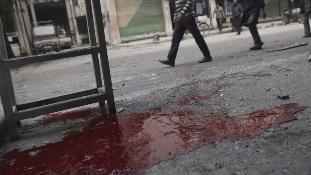 People walk past blood on the ground after what activists said was shelling by forces of Syria''s President Assad in Arbeen, in the eastern Damascus suburb of Ghouta
