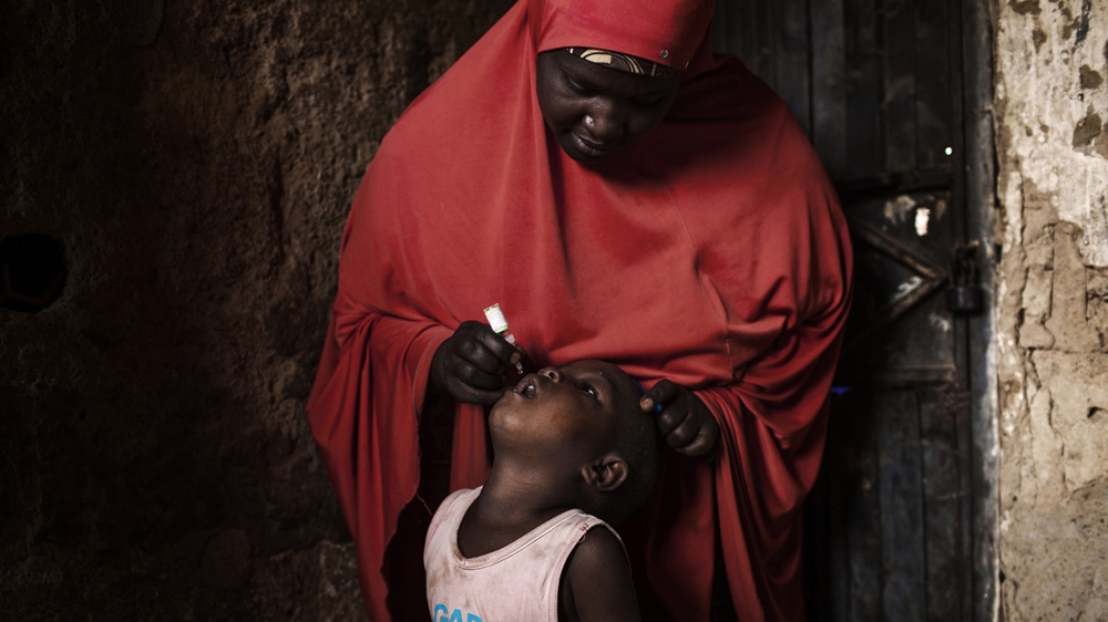 A child receives a polio vaccination on National Immunisation Day in Kano, northern Nigeria [Diego Ibarra Sanchez/MeMo]