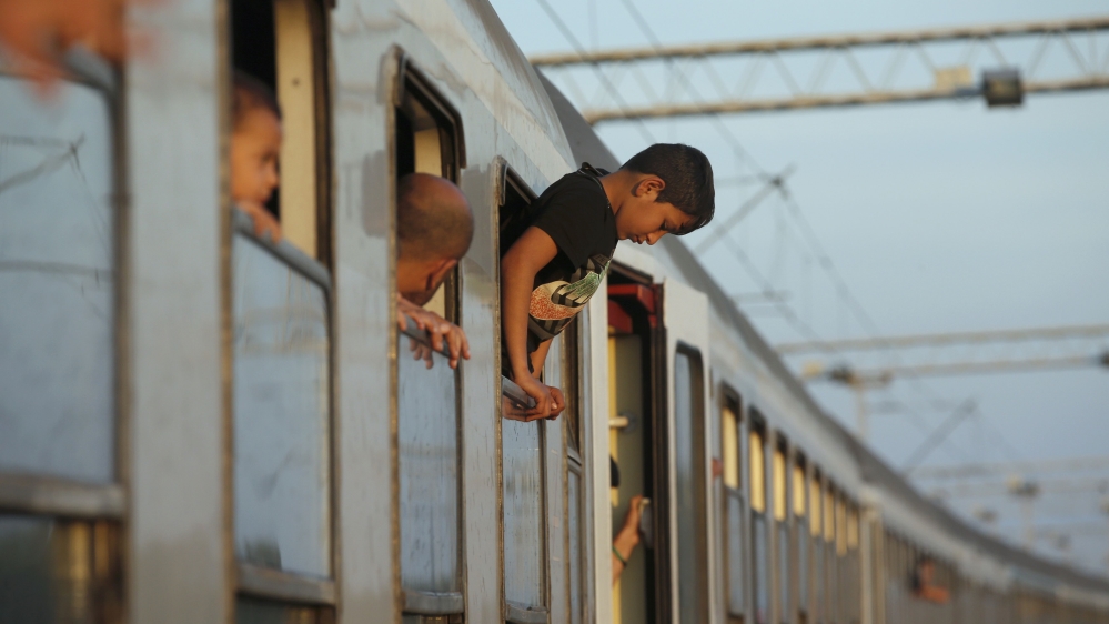Refugee waits to depart from railway station in Tovarnik