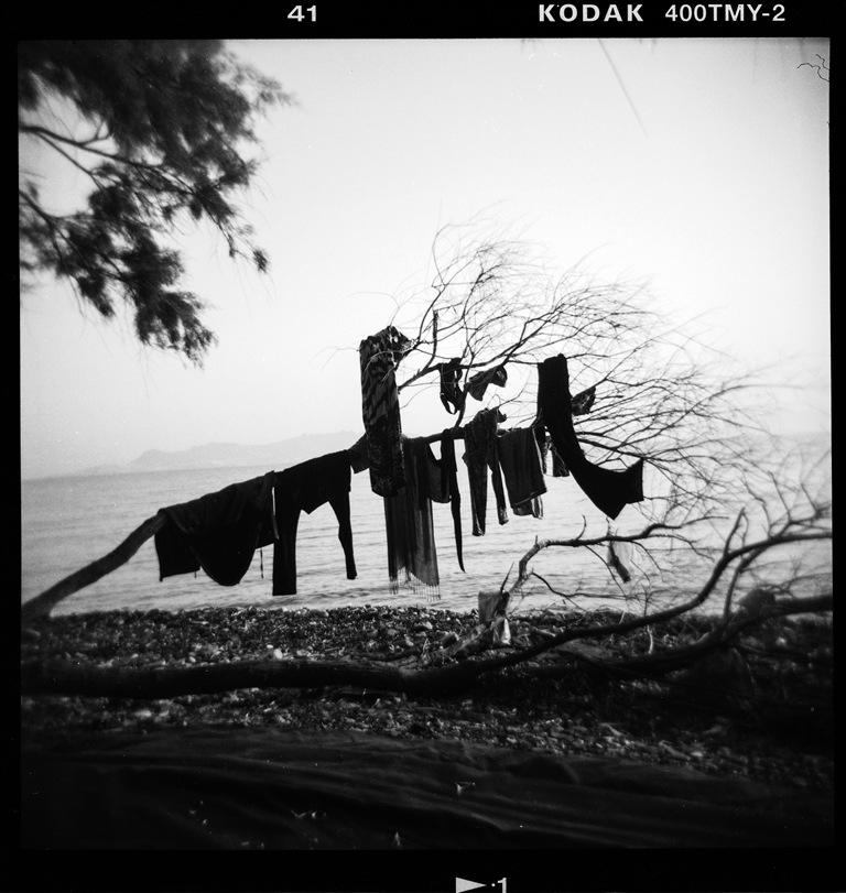 Refugees dry their clothes on a tree on Psalidi beach on the Greek island of Kos – Kos, Greece, August 2015 [Giorgos Moutafis] 