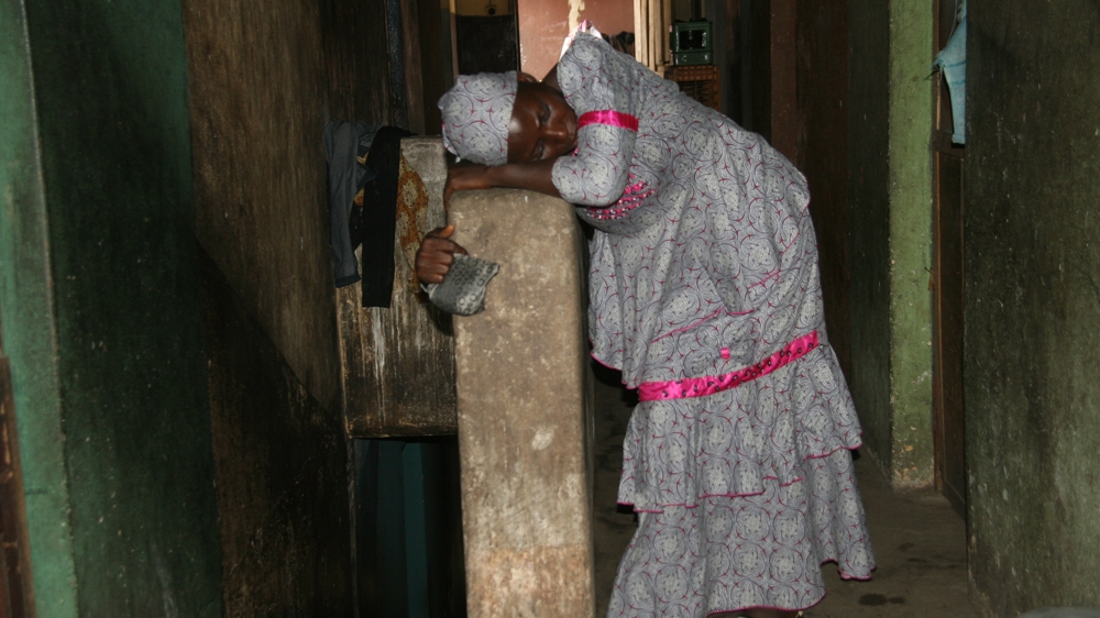 Kafayat has just had her last anti-malarial injection and is feeling weak and exhausted. Still, the mother of four, her children aged between six and 18, must keep going [Abiodun Omotosho/Al Jazeera]