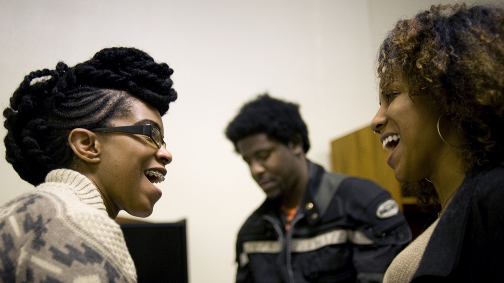 Kim Moore chats with people after a community meeting on police misconduct in San Diego, California [David Maung/Al Jazeera]