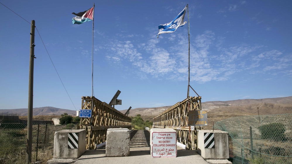 National Jordanian and Israeli flags are seen on the Naharayim bridge on the border between Israel and Jordan north-eastern Israel