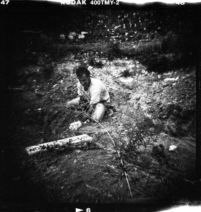 A refugee buries an unnamed Syrian refugee during a funeral ceremony in Mytilene's cemetery - Lesvos, Greece, August 2015 [Giorgos Moutafis] 