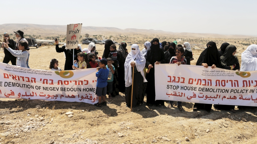 Women, residents of the Umm Al-Hiran, a Bedouin village which is not recognised by the Israeli government, hold banners during a protest in Israel''s southern Negev desert