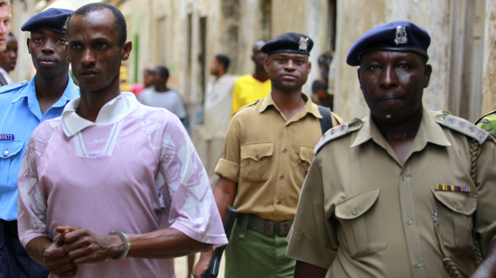 Ali Babitu Kololo is escorted by police to the cells after he was sentenced to death for robbery with violence charges and seven years for participating in the kidnap of British tourists in Lamu