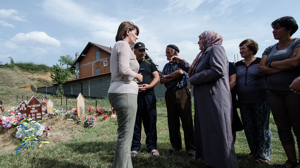 President Jahjaga visits a cemetery in a village where 113 boys and men were killed on March 26, 1999. Village members invited the president to come to their village to express their anger over an incident in which representatives of the European Union Rule of Law Mission in Kosovo, called EULEX, exhumed the graves of bodies a week prior to the president’s visit without giving proper and advance notice to the families. The president invited representatives of EULEX to her office a few days later to discuss the incident [Valerie Plesch/Al Jazeera] 
