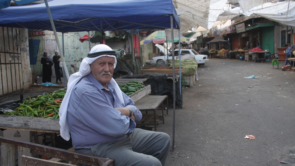 'I have a family to feed - what should I do?' asks Fayez Janjoun, who sells vegetables and fruits in Hebron's Old City [Ylenia Gostoli/Al Jazeera]