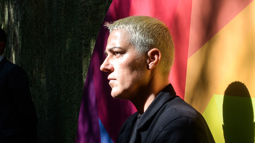 Hikmete Imeraj, the president's long time close protection officer, stands in front of the entrance to the Bunk'Art exhibition, during the president's visit to the bunker turned museum [Valerie Plesch/Al Jazeera] 
