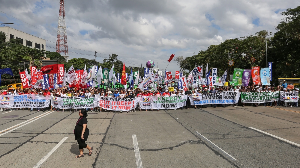 
A Filipino woman walks past demonstrators holding banners during the Global Climate March in Quezon City, northeast of Manila, Philippines [EPA]

 

People hold banners during the Global Climate March in Geneva [EPA]

People hold banners during the Global Climate March in Geneva [EPA]

People hold banners during the Global Climate March in Geneva [EPA]People walk past the art-work 'Where the Tides ebb and flow' by Argentinian artist Pedro Marzorati installed in a pond at the Montsouris park ahead of the COP21 World Climate Summit [Reuters]
Indian school children arrive to present a symbolic globe to the Indian Minister of State for Environment ahead of the COP21 climate change summit in Paris [EPA]

A polar bear-costumed person gestures during 'Earth Parade 2015' in Tokyo [EPA]

Police stand around a climate change protester who had been blocking train tracks in front a train which was supposed to take the German environment minister to the climate summit in Paris [EPA]
Employees put the final touches during the installation of the exhibition 'Paris de L'Avenir,' a showcase for tangible climate solutions in the context of COP21, in front of Paris City Hall [Reuters]