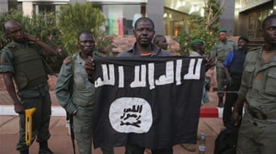 Malian security officials show a flag they said belonged to attackers in front of the Radisson hotel in Bamako [Joe Penney/Reuters]Malian soldiers display grenades and other supplies they said belonged to the attackers [Joe Penney/Reuters]A forensic police official is seen at the Radisson hotel [Joe Penney/Reuters]People cheer soldiers in front of the Radisson hotel [Joe Penney/Reuters]
