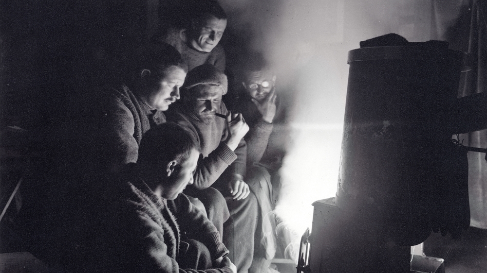 The men onboard Endurance before the ship sank in the Weddell Sea. A sixth man can just be seen behind the man with the glasses. Courtesy: RGS-IBG