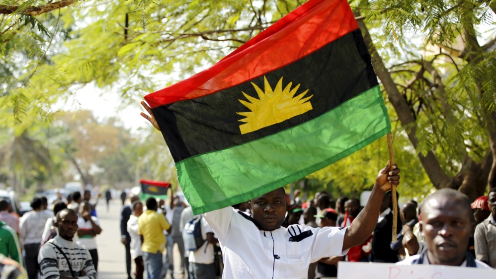 A supporter of Indigenous People of Biafra (IPOB) leader Nnamdi Kanu holds a Biafra flag during a rally in support of Kanu, who is expected to appear at a magistrate court in Abuja