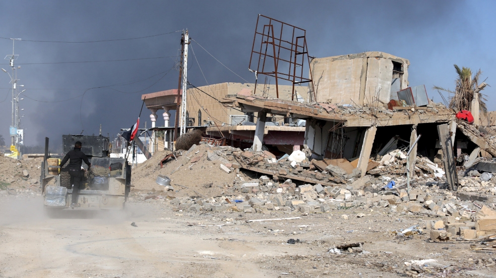 A destroyed building is seen near a government complex in the city of Ramadi
