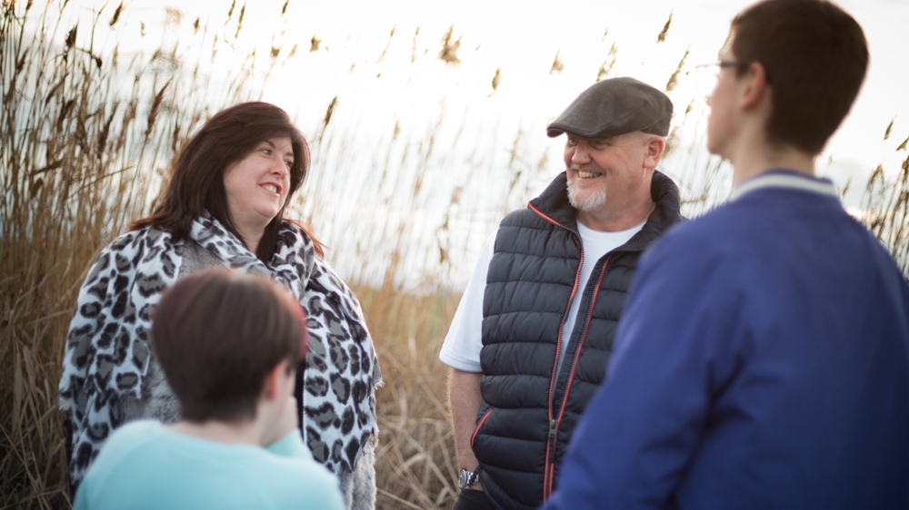 Louise and Harry with Sharon and Paul. Louise is the youngest of the family's children and has been diagnosed with FAS, the most easily recognisable of the five conditions that fall under the FASD umbrella because of the distinct facial characteristics that are among its defining features [Michael Mowbray/Al Jazeera]