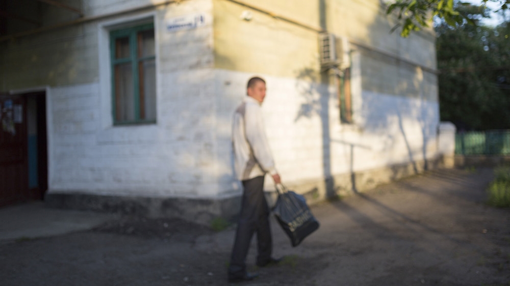 Twenty-nine-year-old Ivan is going to work in Shakhtiorsk at 5:30am, after drinking a couple of beers. He is married and became a father for the first time a few weeks ago. He often jokes about how every day, when he goes to work, he does not know if he will return alive. But when asked if he is afraid, he laughs and says: 'You don't ask this question to a Russian.' [Janos Chiala and Tali Mayer/Al Jazeera]  