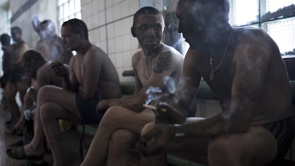 Miners smoke at the end of their shift in a legal mine in Donetsk. Working in a legal mine means taking fewer risks, better working conditions, regular pay and, most importantly, getting a pension. But, it is hard for young miners to find a job in a legal mine, particularly if they have a criminal record or do not have the right connections. [Janos Chiala and Tali Mayer/Al Jazeera]  