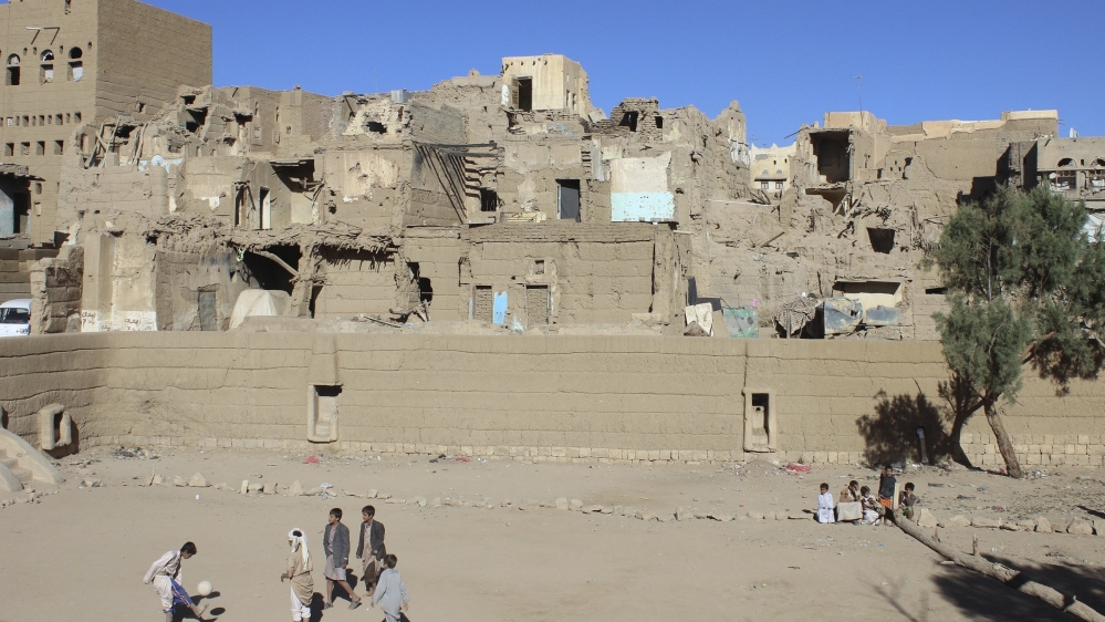 Boys play near houses damaged during recent conflit in Yemen''s northwestern city of Saada