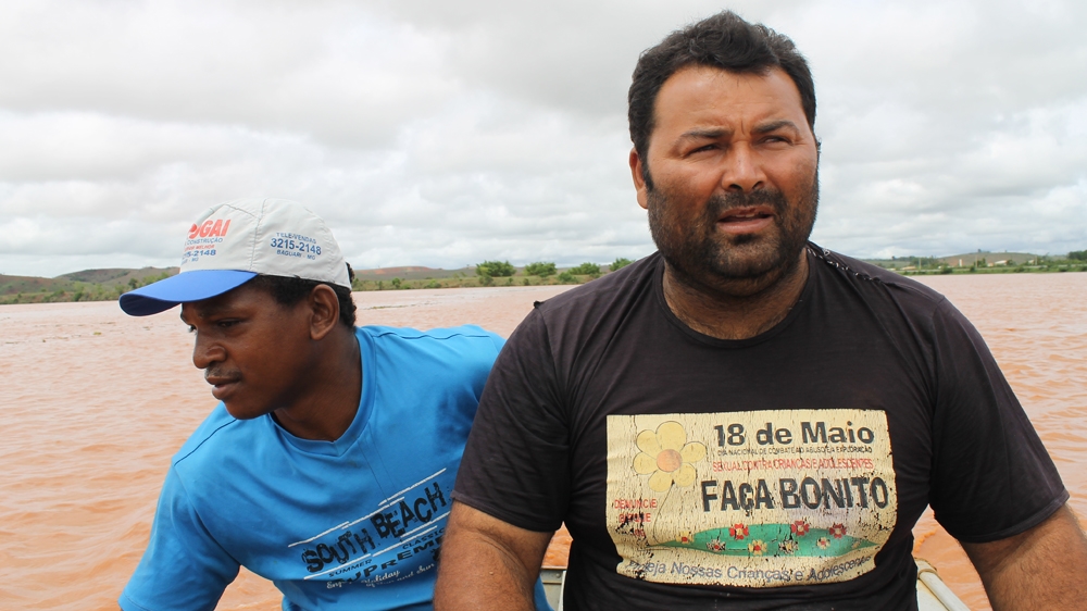 Fishermen on the Rio Doce, some 300km from the dam. The river is polluted and millions of have died [Sam Cowie/Al Jazeera]
