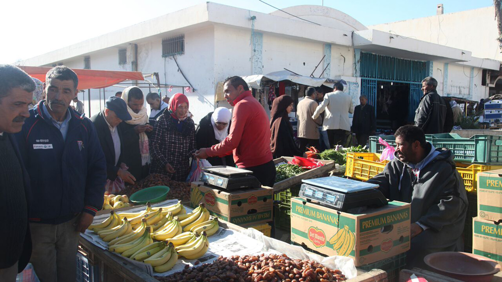 Abdessalam Bouazizi, picture in red, a cousin of Mohamed's, said street vendors still get harassed by police today [Thessa Lageman/Al Jazeera]
