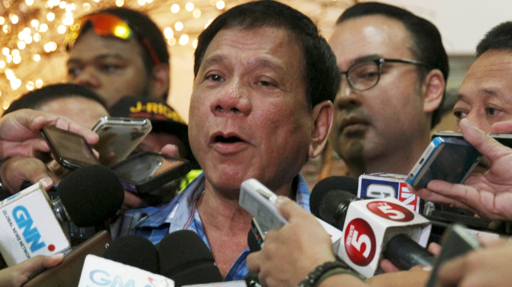 Rodrigo Duterte talks to the media outside the Commission on Elections in Manila