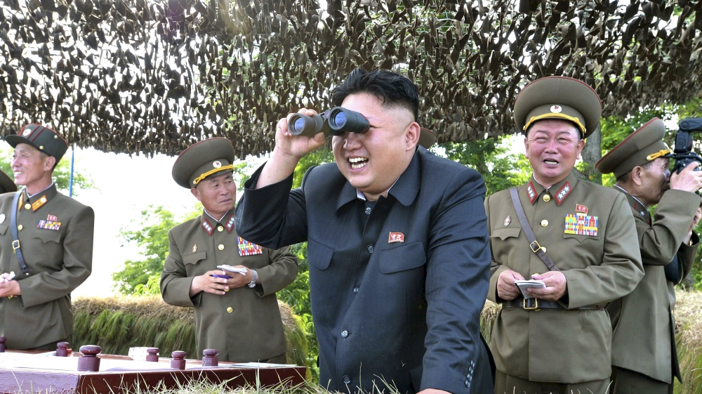 North Korean leader Kim Jong Un looks through a pair of binoculars during an inspection of the Hwa Islet Defence Detachment [Reuters]