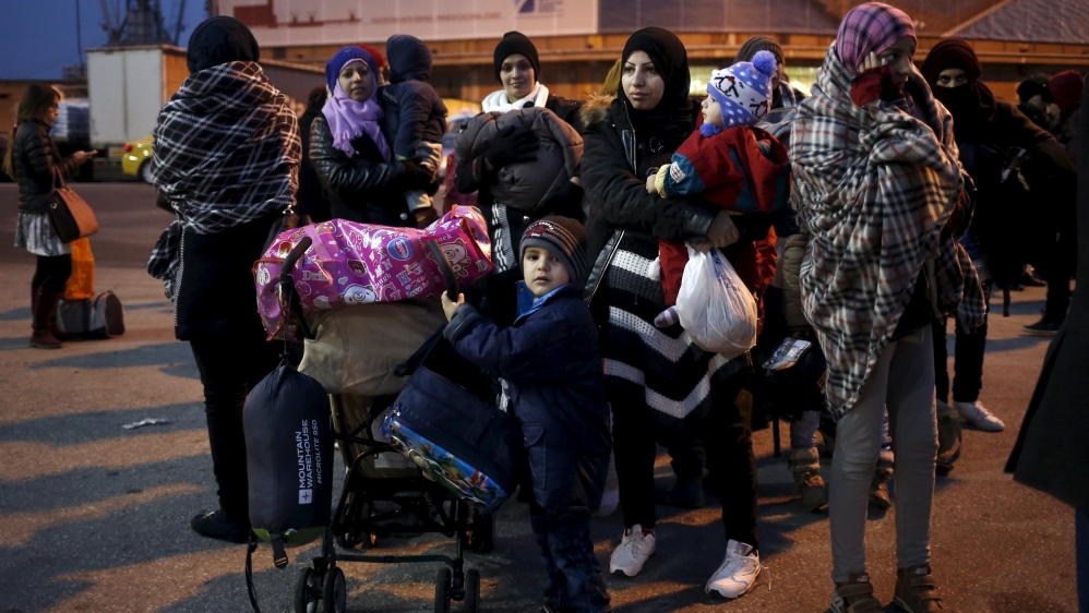 Refugees and migrants arrive aboard the passenger ferry Nissos Rodos at the port of Piraeus, near Athens