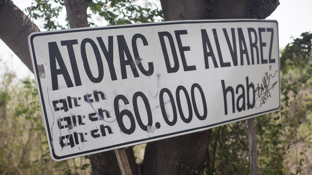 A sign at the entrance to Atoyac, Guerrero, says its population is 60,000 [Alejandro Saldivar/Al Jazeera]