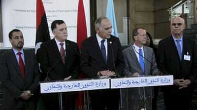 Representatives of the two rival Libyan governments with the UN special representative after signing the Libyan Political Agreement in Morocco [REUTERS]
