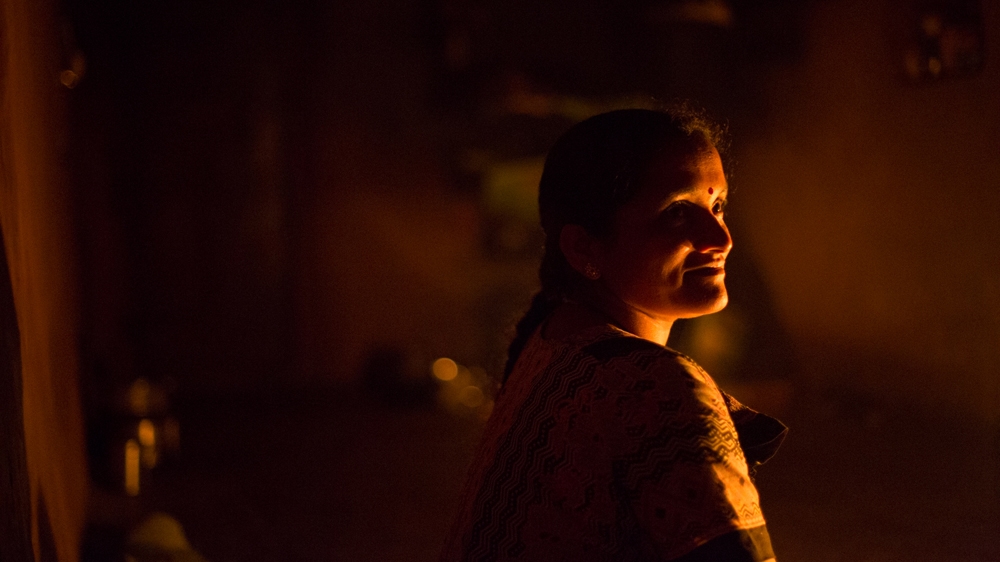 
Rajmati lights kerosene lamps during the monsoon when the electricity often goes out for days [Vivek Muthuramalingam/Al Jazeera]
