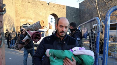 Thousands of people flee from the historic Sur district of the mainly Kurdish city of Diyarbakir [AP]