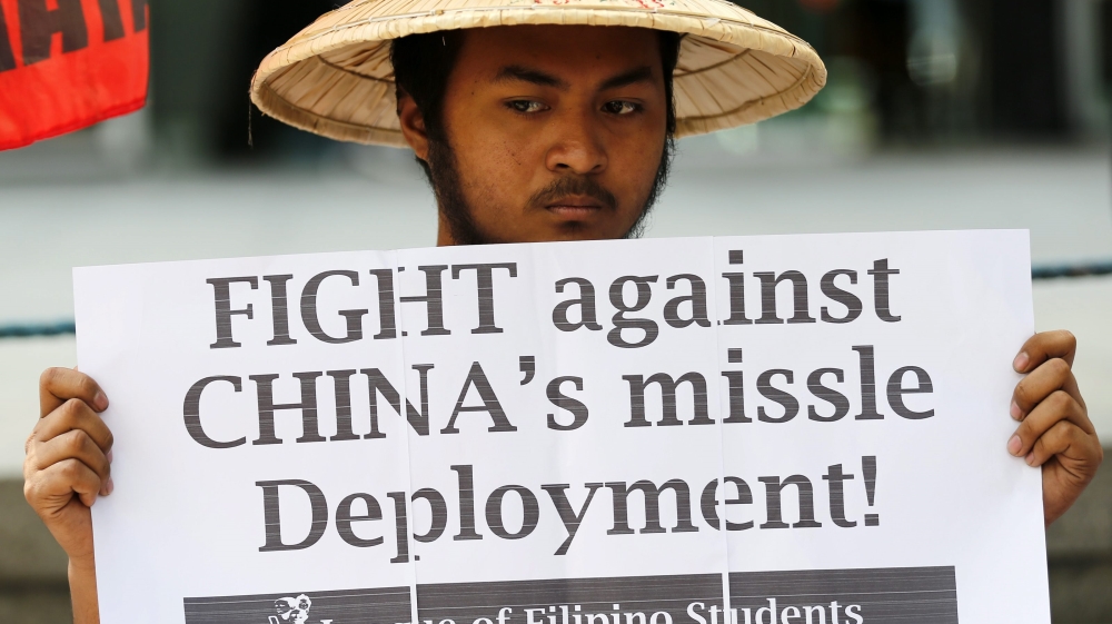 Filipinos protest against China's deployment of a surface-to-air missile system in the disputed South China Sea [EPA/Francis Malasig]