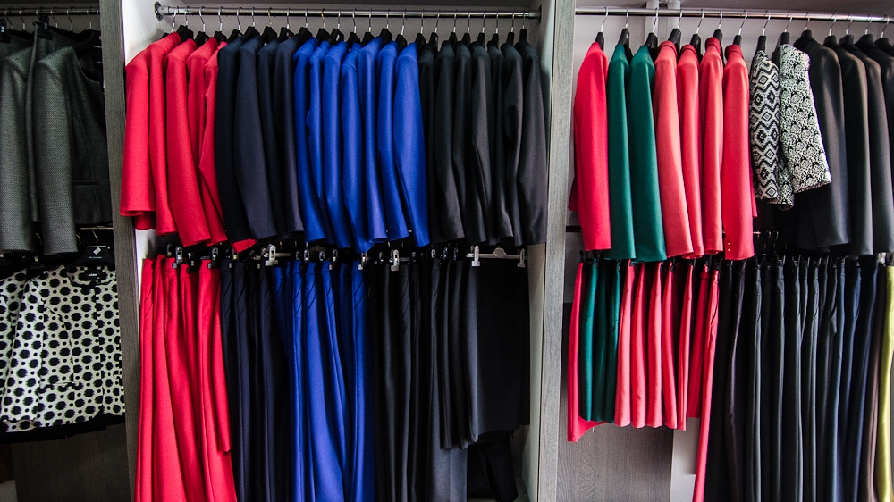 Trouser and skirt suits on display inside the 'Hillary' boutique in downtown Pristina [Valerie Plesch/Al Jazeera]