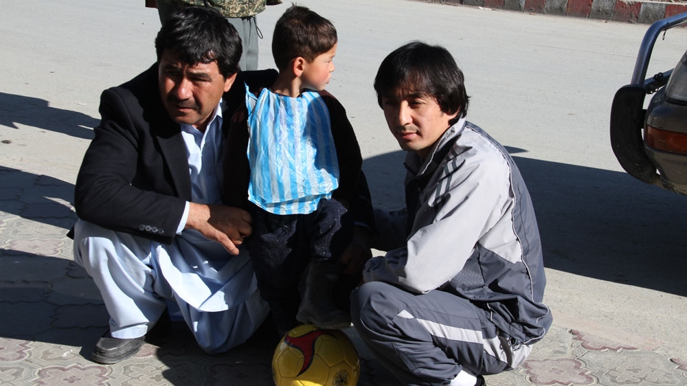Ahmadi's father admitted he could not afford to buy him a replica jersey, adding that his son only had a punctured ball to play [Fatima Faizi/Al Jazeera]