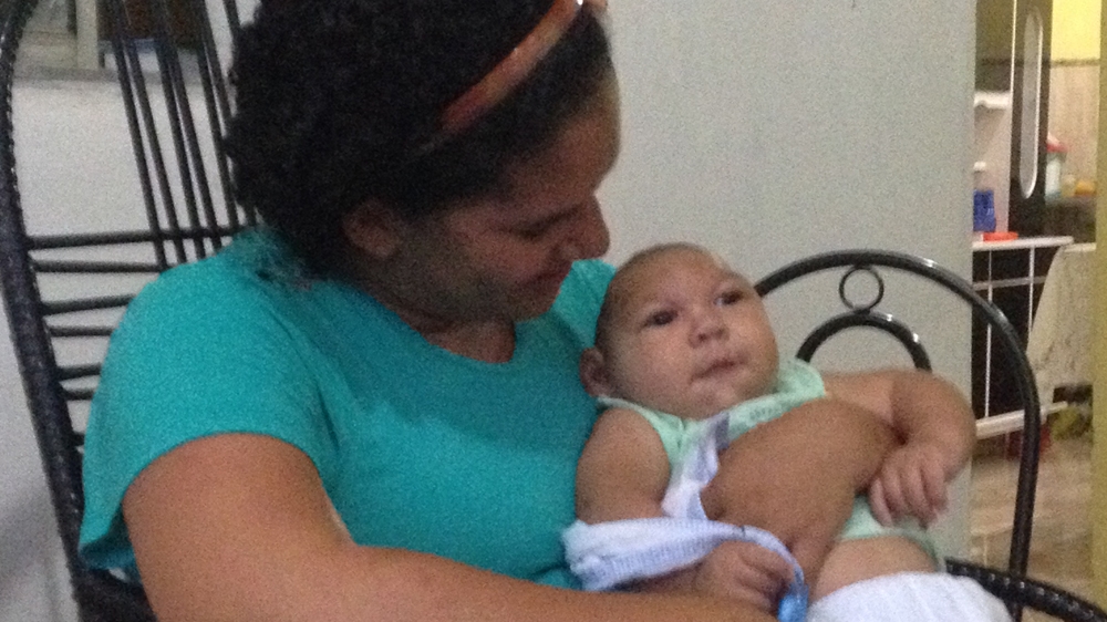Jaqueline Vieira de Souza with her son, Daniel [Zoe Sullivan/Al Jazeera]