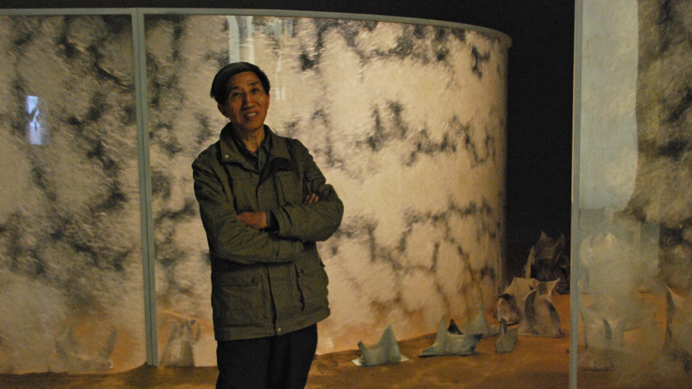 Artist Liang   Shaoji   utilised 30,000 silkworms over three years to create his work [Anna Nigmatulina/Al Jazeera]