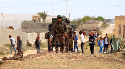 Tunisian soldiers patrol Ben Gardane a day after clashes with ISIL fighters near the border with Libya [EPA] 