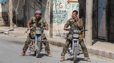 YPG fighters in central Tal Abyad, Syria [Getty]