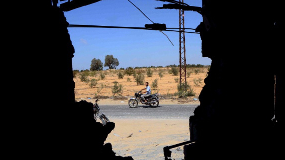 A man is seen riding his motorbike through a wall that was destroyed by an attack by the Egyptian Army the day before in a village on the outskirt of a Northern Sinai town [Getty]
