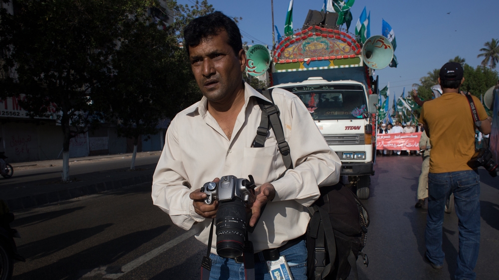 Khan and his co-workers cover the dangerous streets of Karachi with motorbikes, which allow them to quickly get in and out of hazardous news scenes [Max Becherer/Al Jazeera] 
