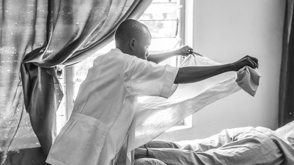 James Pitia covers the legs of a client before beginning their massage. The vigorous Japanese style massage uses sheets to create a barrier as no oil is used [Zach Krahmer/Al Jazeera] [Daylife]