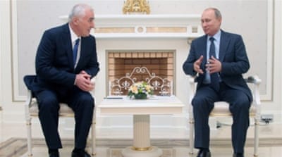 South Ossetia's President Leonid Tibilov with Russian President Vladimir Putin in 2013 in Sochi, Russia [Getty]