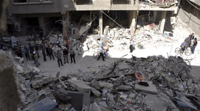 Residents inspect a site hit by what activists said were barrel bombs thrown by forces loyal to Syria''s President Bashar Al-Assad, in the Palestinian Yarmouk refugee camp, southern outskirt