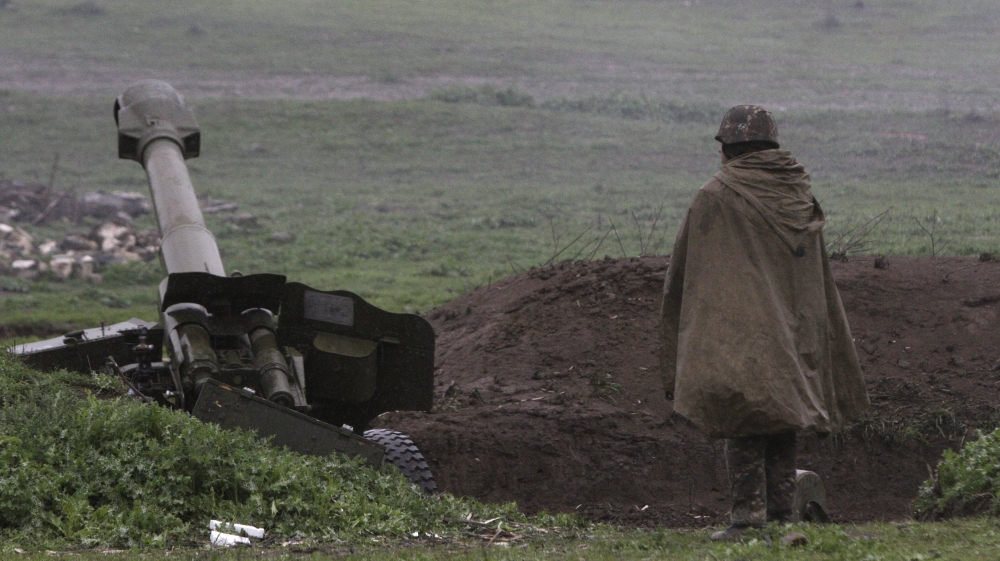 Armenian soldier of self-defense army of Nagorno-Karabakh stands near artillery unit in Martakert where clashes with Azeri forces are taking place in Nagorno-Karabakh region